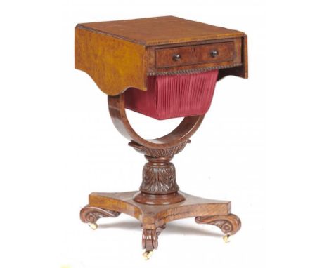 AN EARLY VICTORIAN BURR ELM WORKTABLE the drop-leaf top with sliding bag on U shaped bracket and carved pillar, platform and 