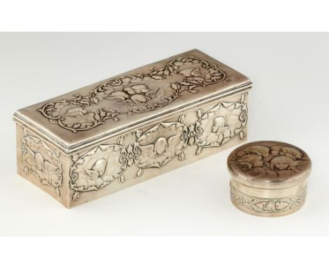 TWO EDWARD VII SILVER TRINKET BOXES  the rectangular lid or bun cover and sides die stamped with cherubs' heads, 23.5cm l and