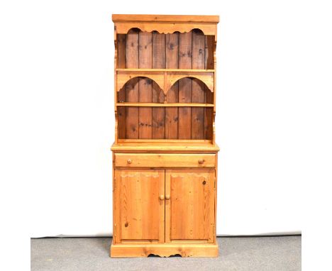 Pine kitchen dresser, of narrow proportions, the back with open shelf and recesses, the base with long drawer and cupboard, w