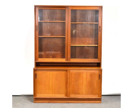 Mid-century teak bookcase cabinet, Swedish, model 321, the glazed upper section with adjustable shelves, above pair of slidin