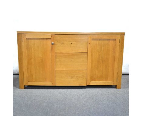 Contemporary oak sideboard, three central drawers flanked by two cupboards, width 137cm, depth 46cm, height 76.5cm.Condition 