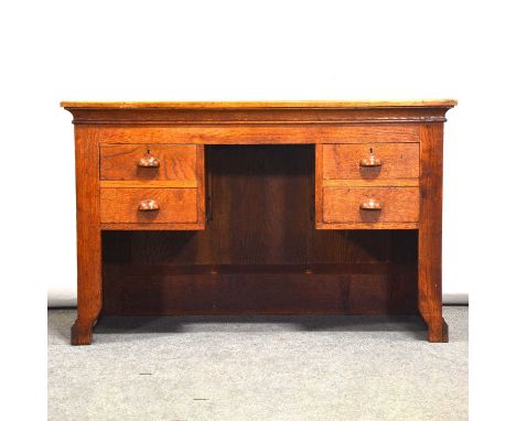 Small Edwardian oak desk, plain rectangular top, panelled sides and back, the kneehole flanked by two short drawers to each s