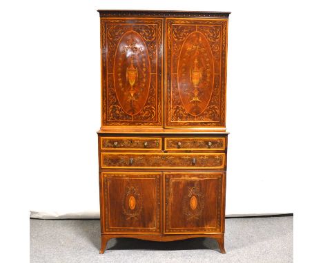 George III mahogany and marquetry cupboard, pendant frieze above two door enclosing shelves, the base with three drawers over