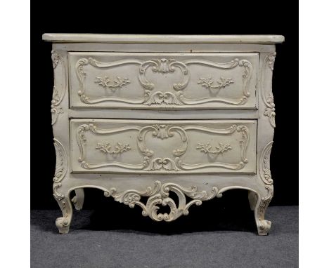French two drawer commode, white painted, the drawers with applied scrolls, carved acanthus apron and cabriole legs, width 97
