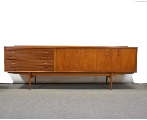 Robert Heritage for Archie Shine, a 'Hamilton' design teak low-profile sideboard, with twin folding cupboard doors and four d