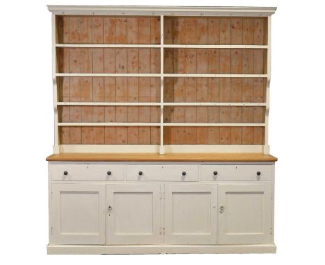 Large part painted pine dresser, the gallery back fitted with four shelves, waxed pine top above three drawers and pair of cu