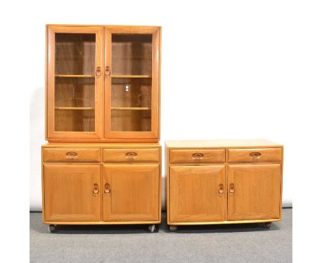 Two elm sideboard units, each with two drawers and two doors, raised on ball castors, together with an upper glazed bookcase 
