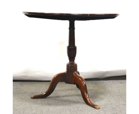 George III oak tripod table, circular tilt top on a turned and ringed column, splayed legs, diameter 77cm, height 67cm.Condit