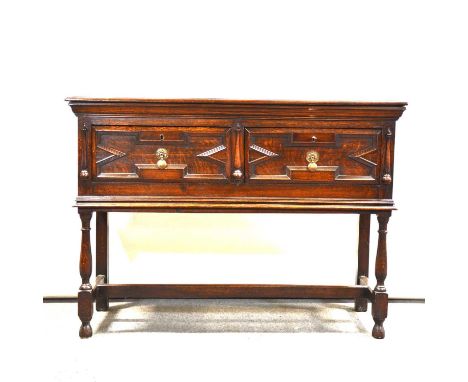 Jacobean style oak dresser base, boarded top with moulded edge, two drawers with applied mouldings, turned legs joined by str