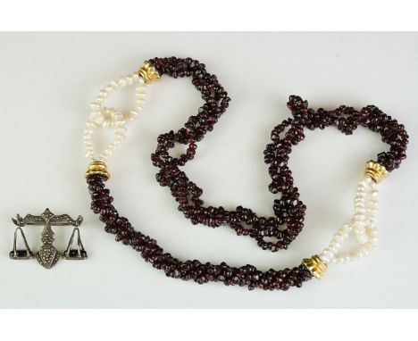A garnet and natural pearl necklace together with a white metal marcasite brooch in the form of scales. 