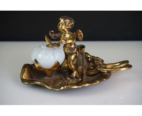 19th Century gilt metal desk inkwell modelled as a cherub on a lily pad, the cherub rotates to allow access to the ink from t