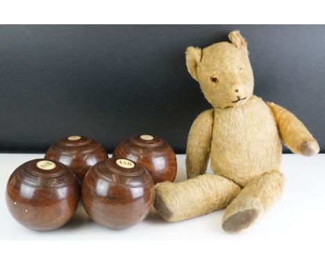 Set of four wooden lawn bowls, together with a vintage teddy bear 