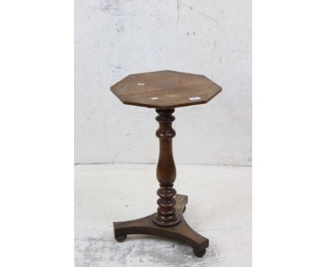 19th century Mahogany Lamp Table with octagonal top, turned pedestal and a platform base with three ball feet, 40cm wide x 68