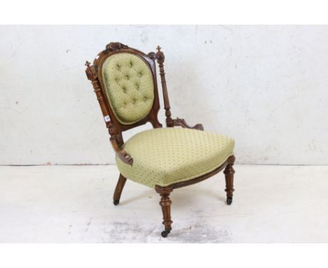 Victorian Carved Walnut Nursing Chair, with green floral button back upholstery, 51cm wide x 82cm high 