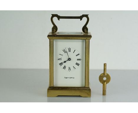 A Mappin &amp; Webb brass cased carriage clock with bevelled glass panels, complete with key.