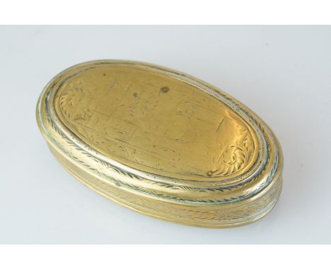 An antique 18th century oval brass snuff box with ornate chased decoration. 