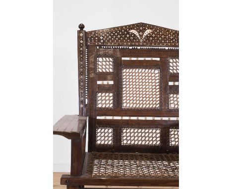 A bone and ivory-inlaid hardwood armchair, late 19th/early 20th century, Swahili, the arched back with geometric decoration, 