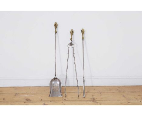 A set of three Regency brass and steel fire tools, c.1840, each with rococo handles,shovel 15.5cm wide81cm long (3)
