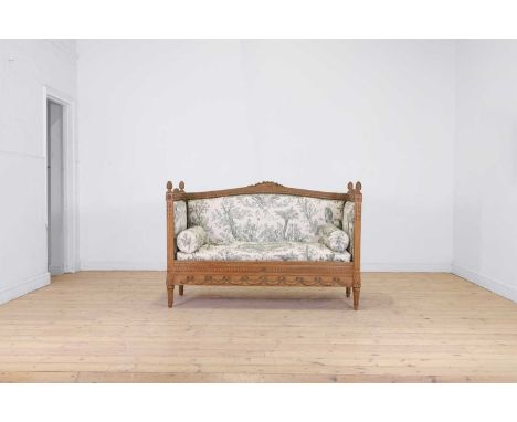 A Louis XVI-style carved beech settee, late 19th/early 20th century, the carved and crested top rail and arms with acorn fini