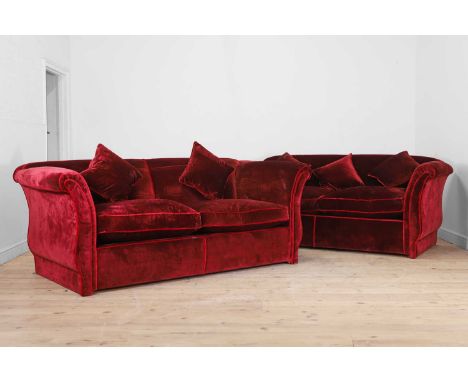 A pair of red velvet two-seater sofas, of recent manufacture, Italian, each with red piping and loose cushions,217cm wide105c