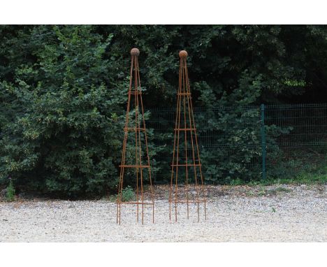 A pair of conical metal obelisk planters, each with a ball finial,54cm diameter233cm high (2)