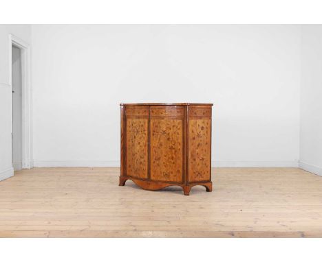 A George III satinwood, rosewood and marquetry side cabinet, c.1790, the book-matched serpentine top with a tied foliate spra