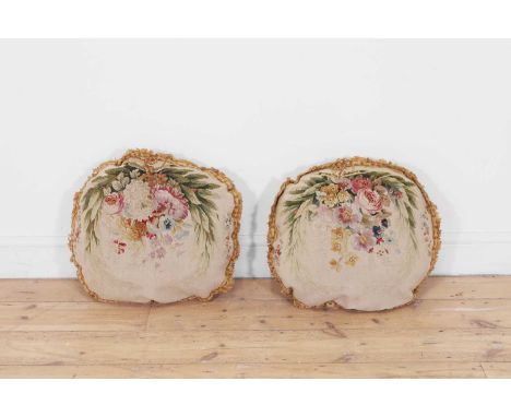 A pair of oval Beauvais wool and silk tapestry cushions, 18th/19th century, each depicting a floral bouquet with roses and pe