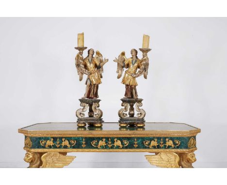 A pair of carved, painted, silvered and giltwood torchères, 19th century, Italian, each polychrome-decorated figure with one 