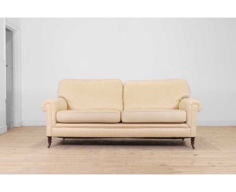 A two-seater sofa by George Smith, of recent manufacture, upholstered in a cream herringbone fabric, raised on turned support