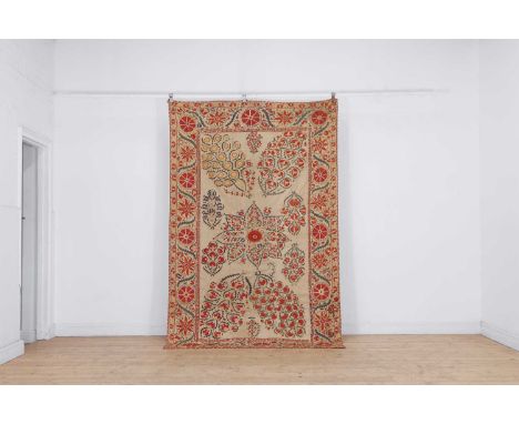 A Nurata silk embroidered suzani, late 19th/early 20th century, Uzbekistan, worked in pink, red and green threads on six cott