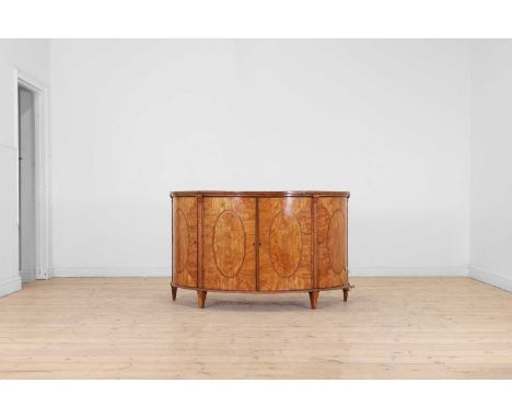 A George III Sheraton period satinwood and tulipwood demilune side cabinet, c.1790, the segmented crossbanded top above four 