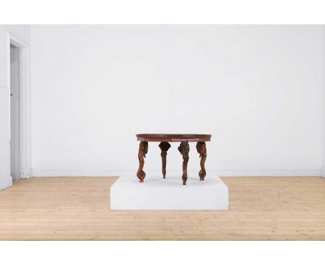 A hardwood and ivory low table,  early 20th century, Indian, the circular top with inlaid floral and foliate decoration, rais