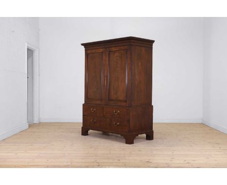 A small George III mahogany linen press, third quarter of the 18th century, with a dentil-moulded cornice, above a pair of pa