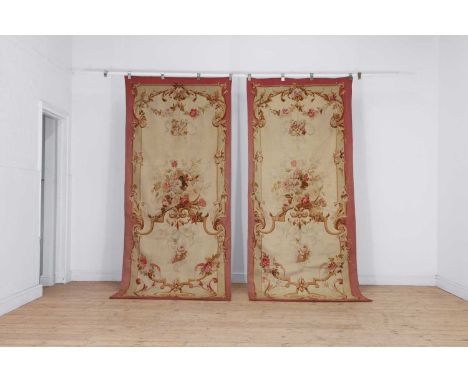 A pair of Aubusson tapestry wall hangings, 19th century, each with a central motif with a lute to a biscuit field, with flora