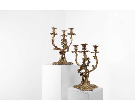 A pair of Louis XV-style gilt-bronze candelabra,  late 19th/early 20th century, French, each of scrolling rococo form, with t
