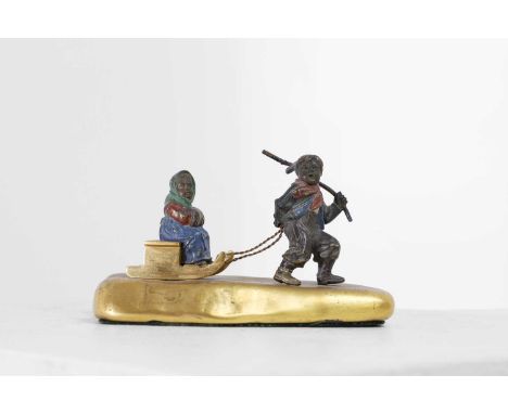 An ormolu and cold-painted bronze figural group, late 19th/early 20th century, probably Austrian, of two children with a sled