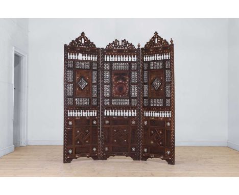 A carved and inlaid wooden screen, early 20th century, Syrian, Damascus, each leaf with an arched top, decorated with arabesq