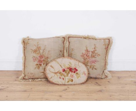 A pair of wool and silk tapestry cushions, 18th/19th century, French, each square sage-green field decorated with floral spra