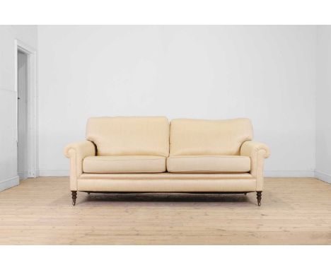 A two-seater sofa by George Smith,  of recent manufacture, upholstered in a cream herringbone fabric, raised on turned suppor