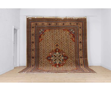 A Persian wool carpet, 20th century, Tabriz, with a central floral medallion and herati motifs to a cream ground, 400 x 304cm