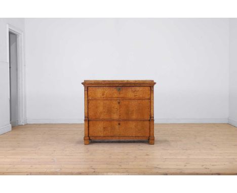 An Empire birch commode, late 18th/early 19th century, Northern European, the stepped rectangular top above three drawers set