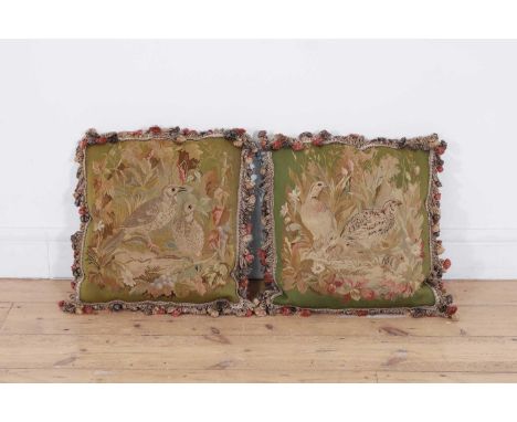 A pair of wool and silk tapestry cushions, 18th/19th century, each of square form, decorated with birds in a naturalistic set