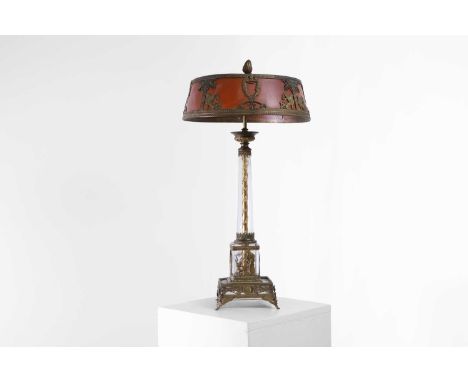 A gilt-metal and glass table lamp in the Empire style, early 20th century, French, the shade decorated in relief with sphinxe