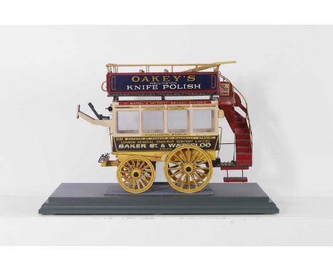 A scale model of an Edwardian horse-drawn bus, 20th century, the wooden body painted with destinations and route information,