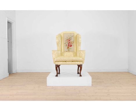 A George I walnut and beech wing armchair, early 18th century and later, upholstered in yellow damask inset with a tapestry p