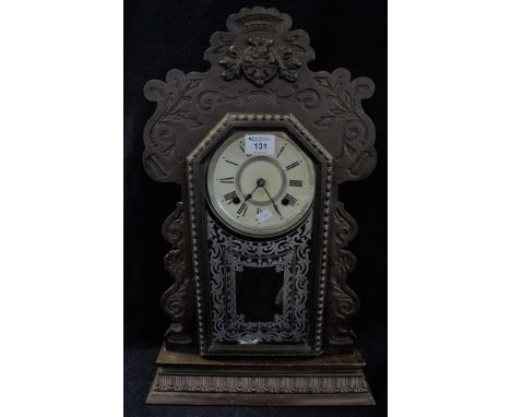 Early 20th Century gingerbread type two train mantel clock with exposed pendulum. (B.P. 24% incl. VAT)