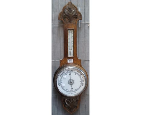 Early 20th Century carved oak aneroid barometer. (B.P. 24% incl. VAT) CONDITION REPORT: Face appears good, not tested if work