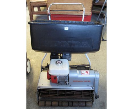 Honda HC 26 rotary mower, together with a towing roller seat. (2) (B.P. 24% incl. VAT)