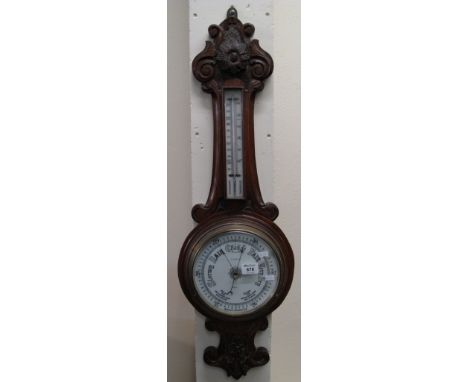 Early 20th Century carved oak aneroid barometer, indistinctly marked. (B.P. 24% incl. VAT)