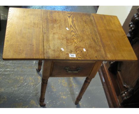 Edwardian oak drop leaf ladies work table on ring turned supports and casters. (B.P. 24% incl. VAT)